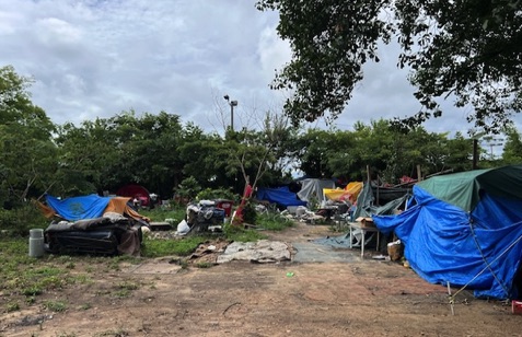 homeless encampment next to stream