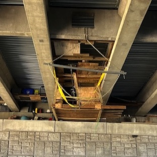 Homeless structure hanging from bridge